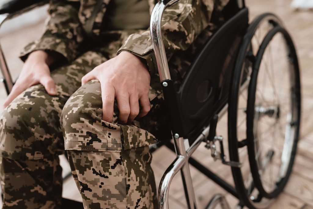Paralysis in Bolton and Army, Navy, Air Force Injury and Accident Compensation - Veteran in wheelchair